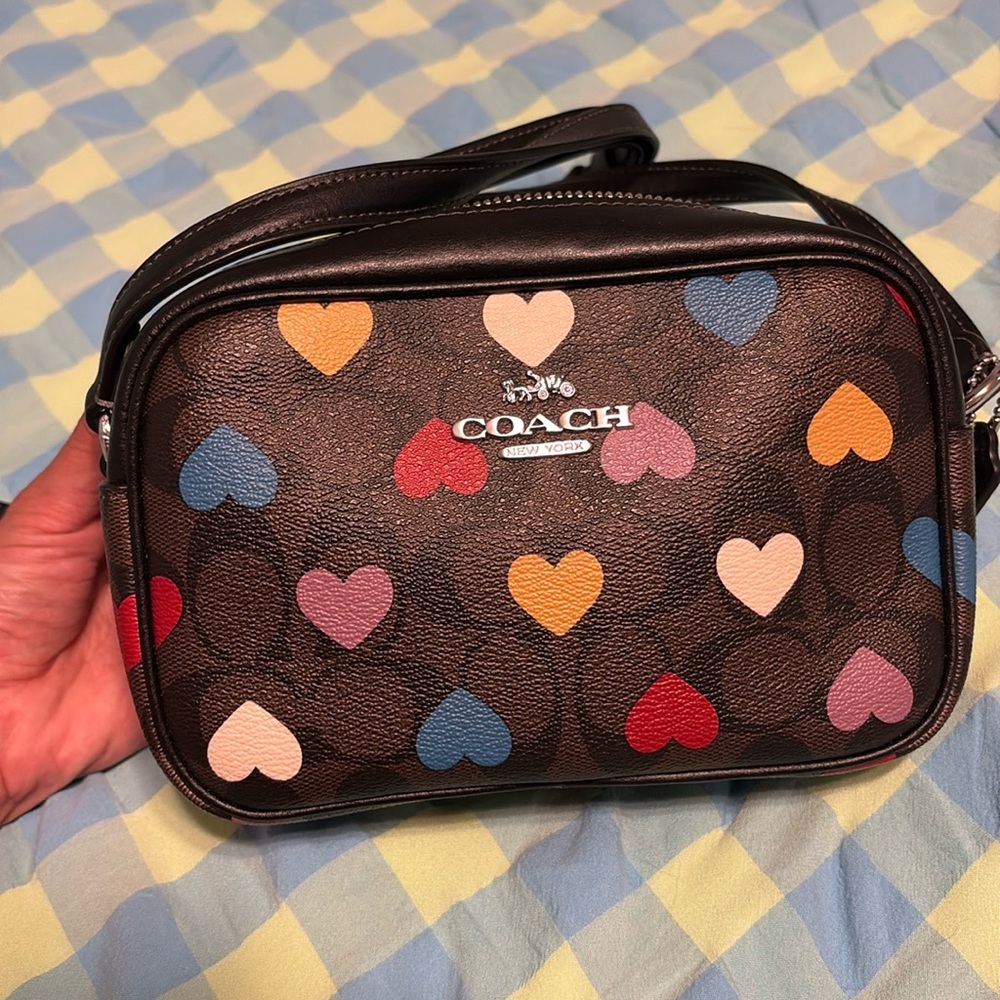 Brown & black crossbody coach purse with multicolored hearts